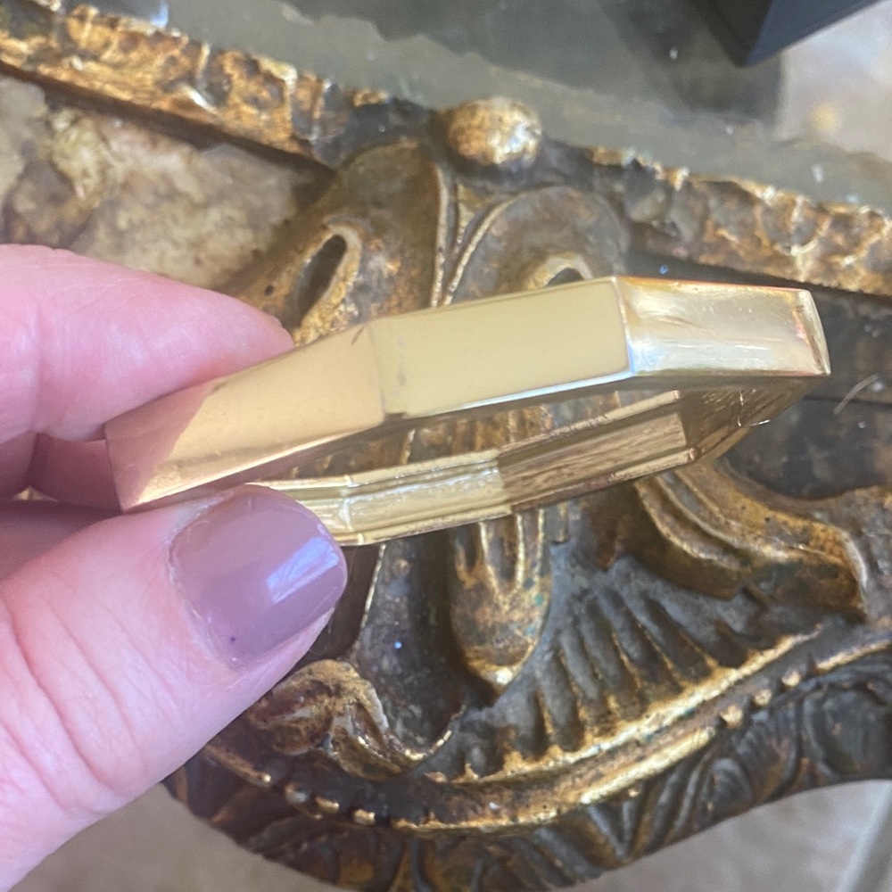 Gold tone hinged geometric bangle. 2.5 inches across.